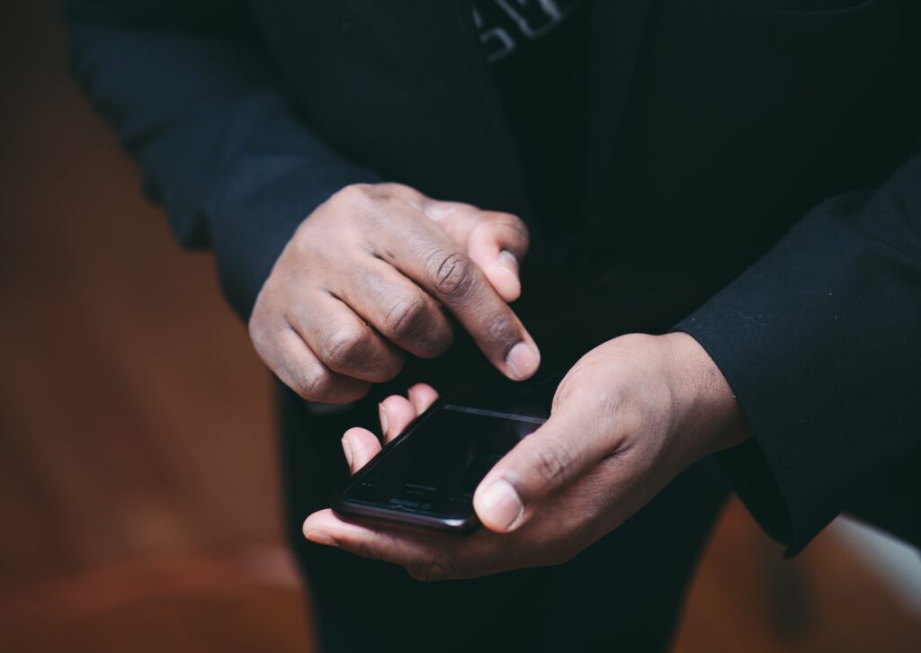 African American man using mobile phone with ring on ring finger