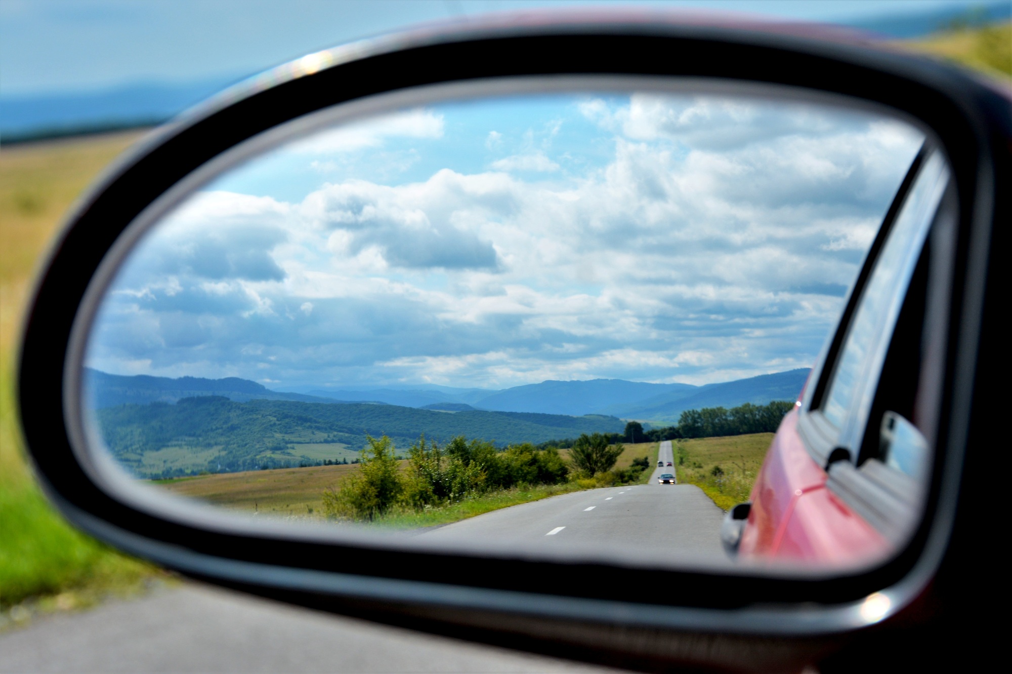 Beautiful picture of the landscape seen through the rearview mirror