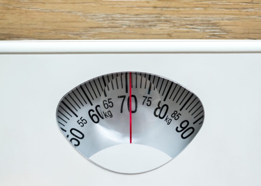 Closeup of weight scales overweight and obesity concept