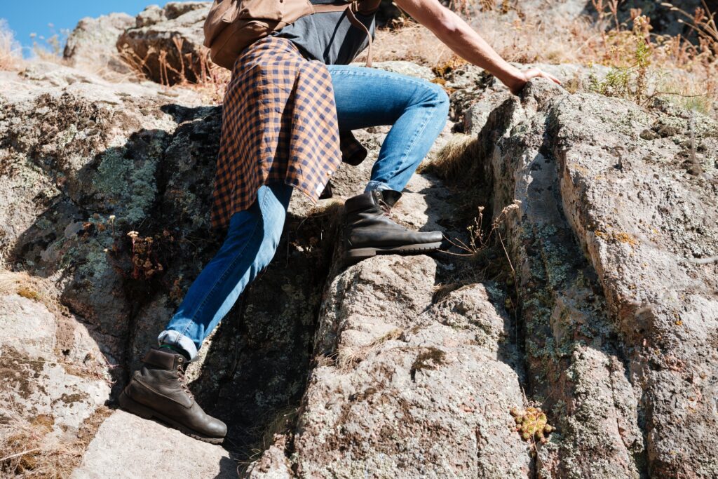 Cropped image of a male hiker climbing mountains