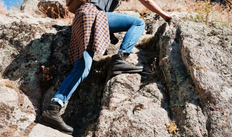 Cropped image of a male hiker climbing mountains